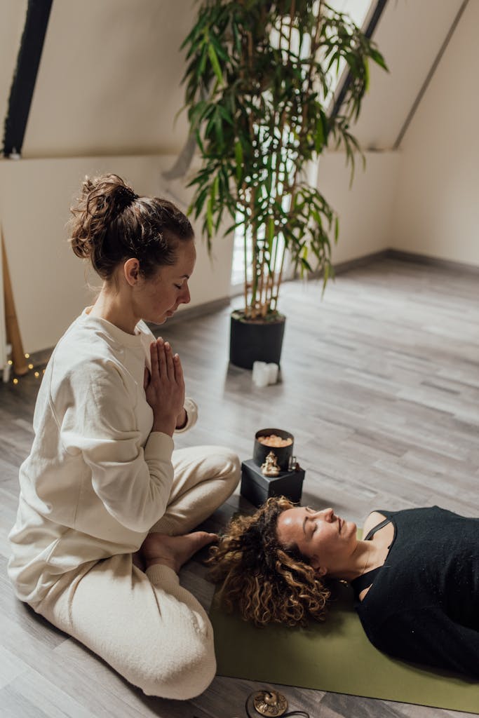A serene scene of a woman meditating indoors promoting peace and relaxation.